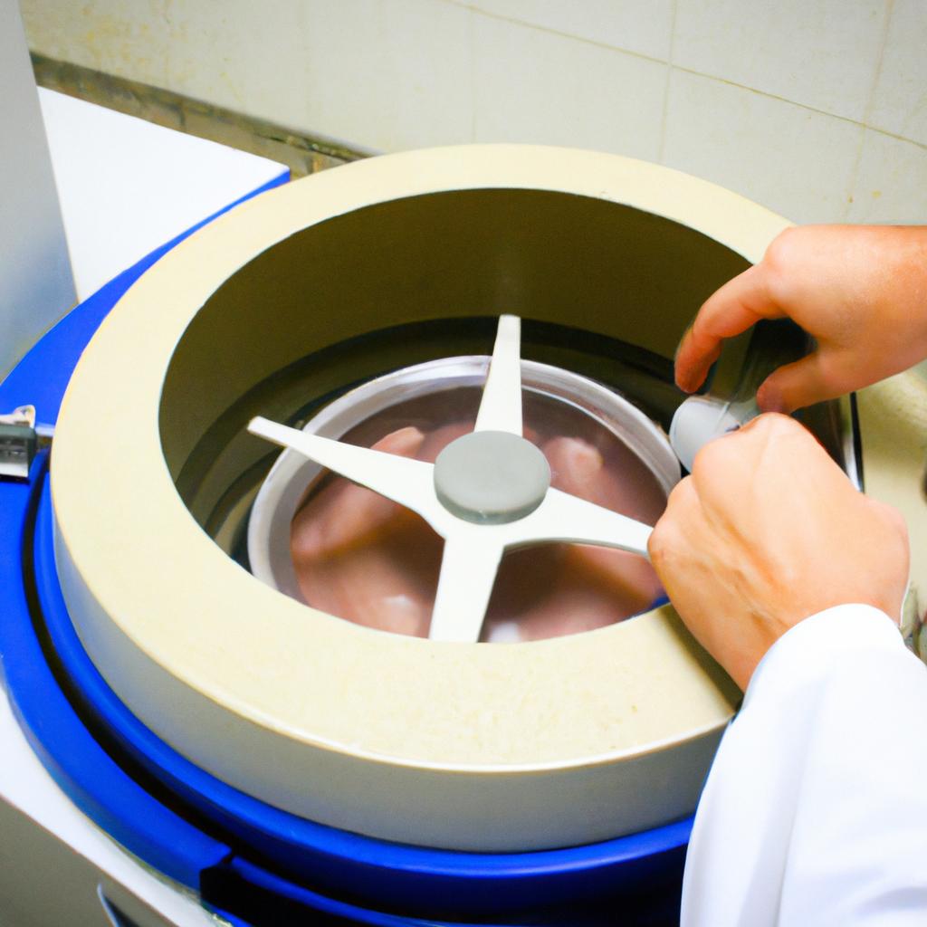 Person operating centrifuge in lab